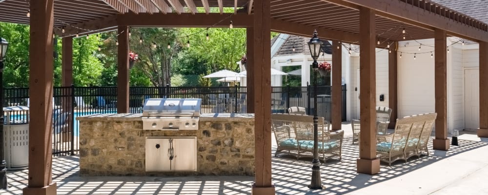 Outdoorgrilling station and seating by the community swimming pool at Renaissance at Galleria in Hoover, Alabama