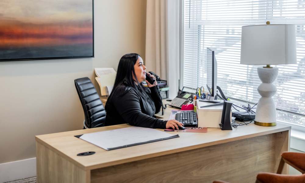 An employee speaking on the phone at the front desk at The Park at Massalina in Panama City, Florida