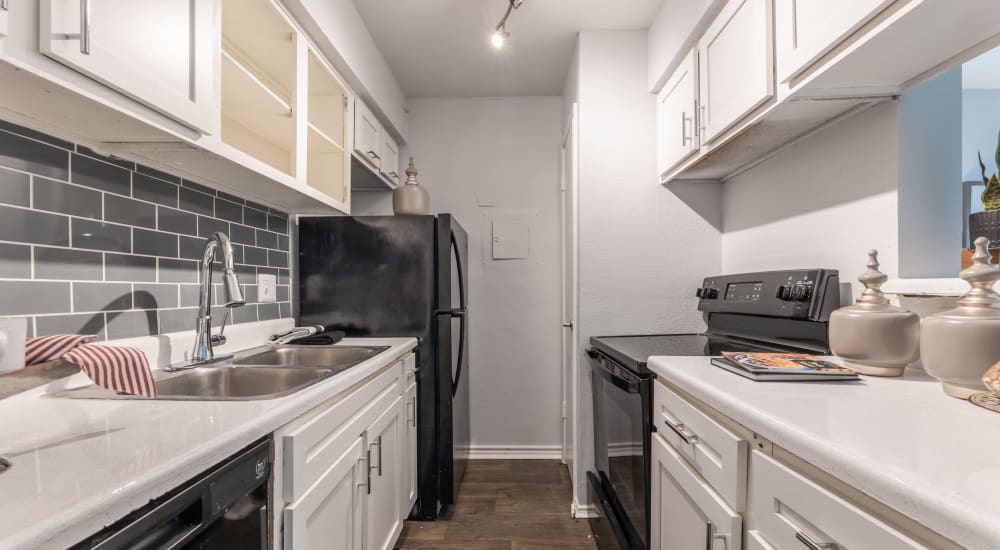 Couple fixes dinner in their new apartment at The Gates in Houston, Texas
