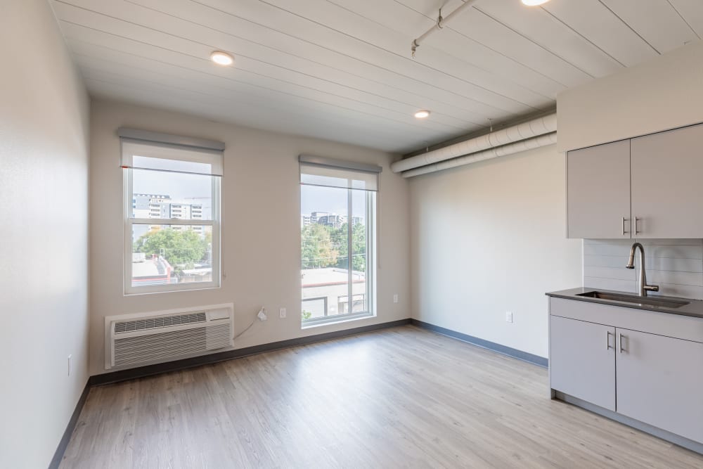 Kitchen area in apartment at Art District Flats in Denver, Colorado features a large window for ample natural light.