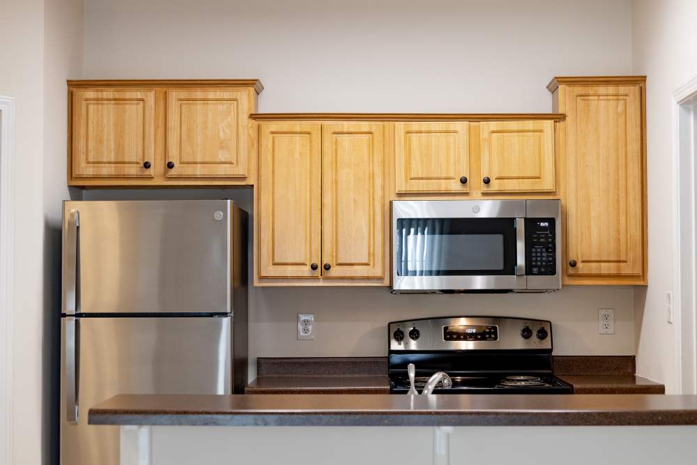 Fully-equipped kitchen with stainless steel appliances and island at Forest Ridge in Bloomington, Indiana,