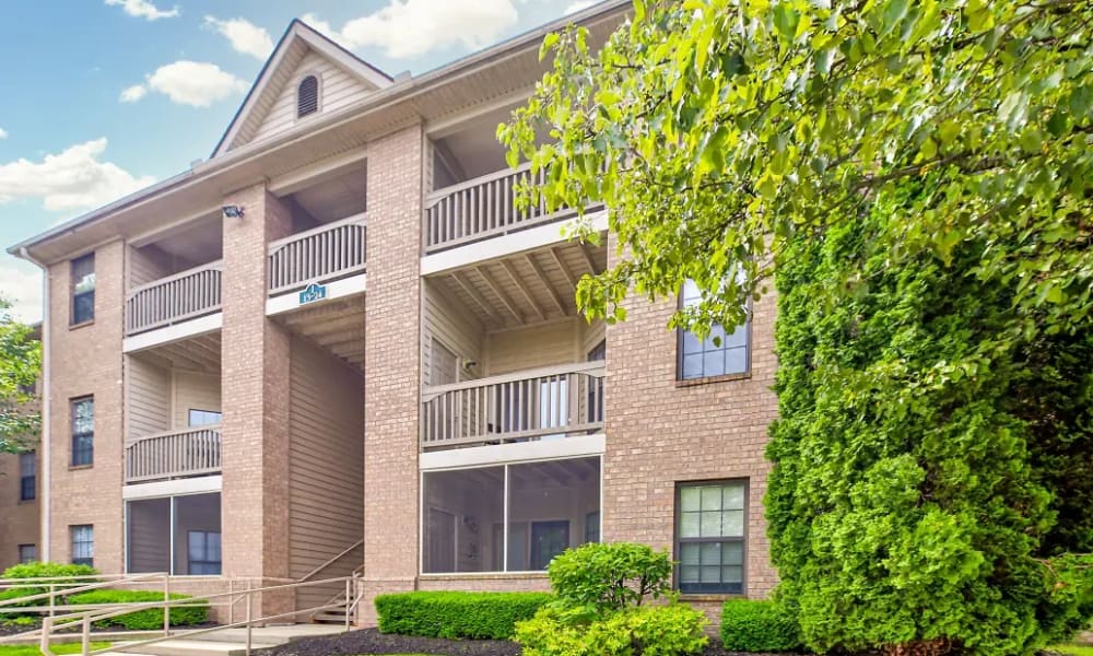 Building exterior with private balconies and screened patios visible at Burlington Oaks in Burlington, Kentucky