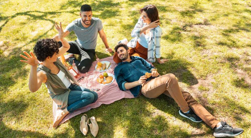 Resident with friends in a park near Meriden Place Apartments in Meriden, Connecticut