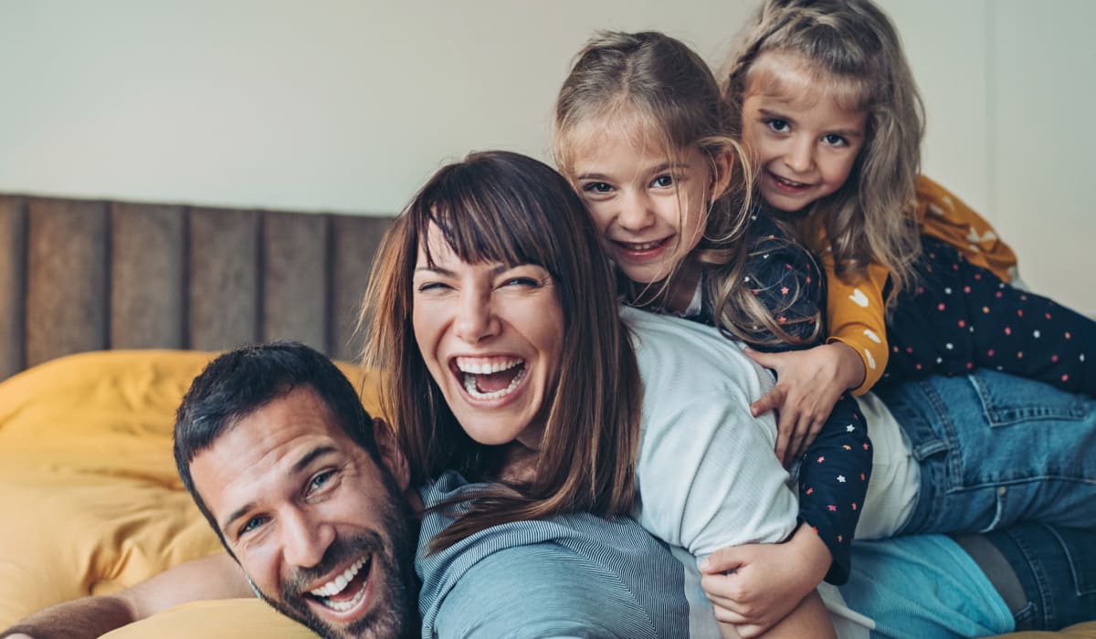 A happy family in their home at Hamlet at MidCity in Huntsville, Alabama