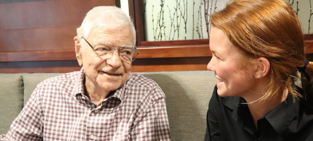 Resident with caregiver at The Springs at Carman Oaks in Lake Oswego, Oregon
