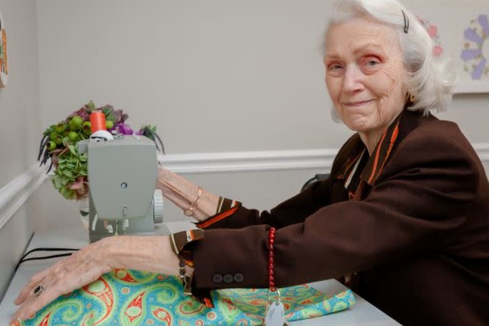 A resident sewing at Mercer Hill at Doylestown in Doylestown, Pennsylvania