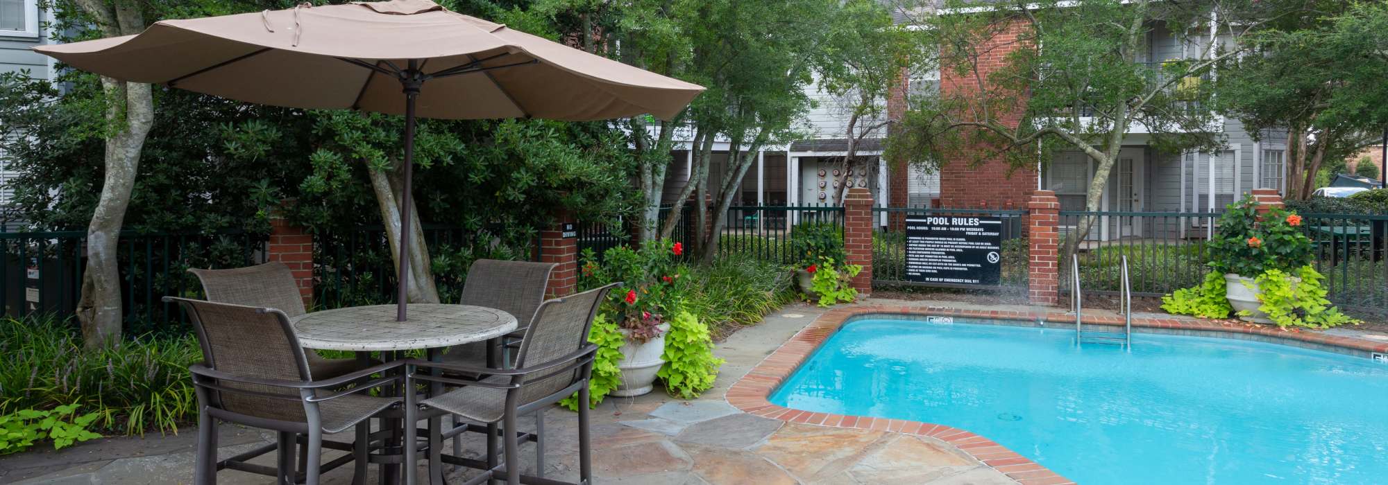 Swimming pool with seating area on the side at Tallow Wood in Bossier City, Louisiana  
