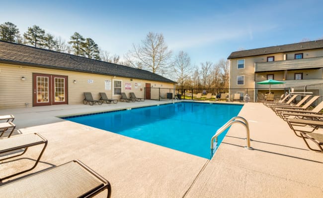 Swimming pool with a spacious sundeck at Alexander Station Apartment Homes in Salisbury, North Carolina