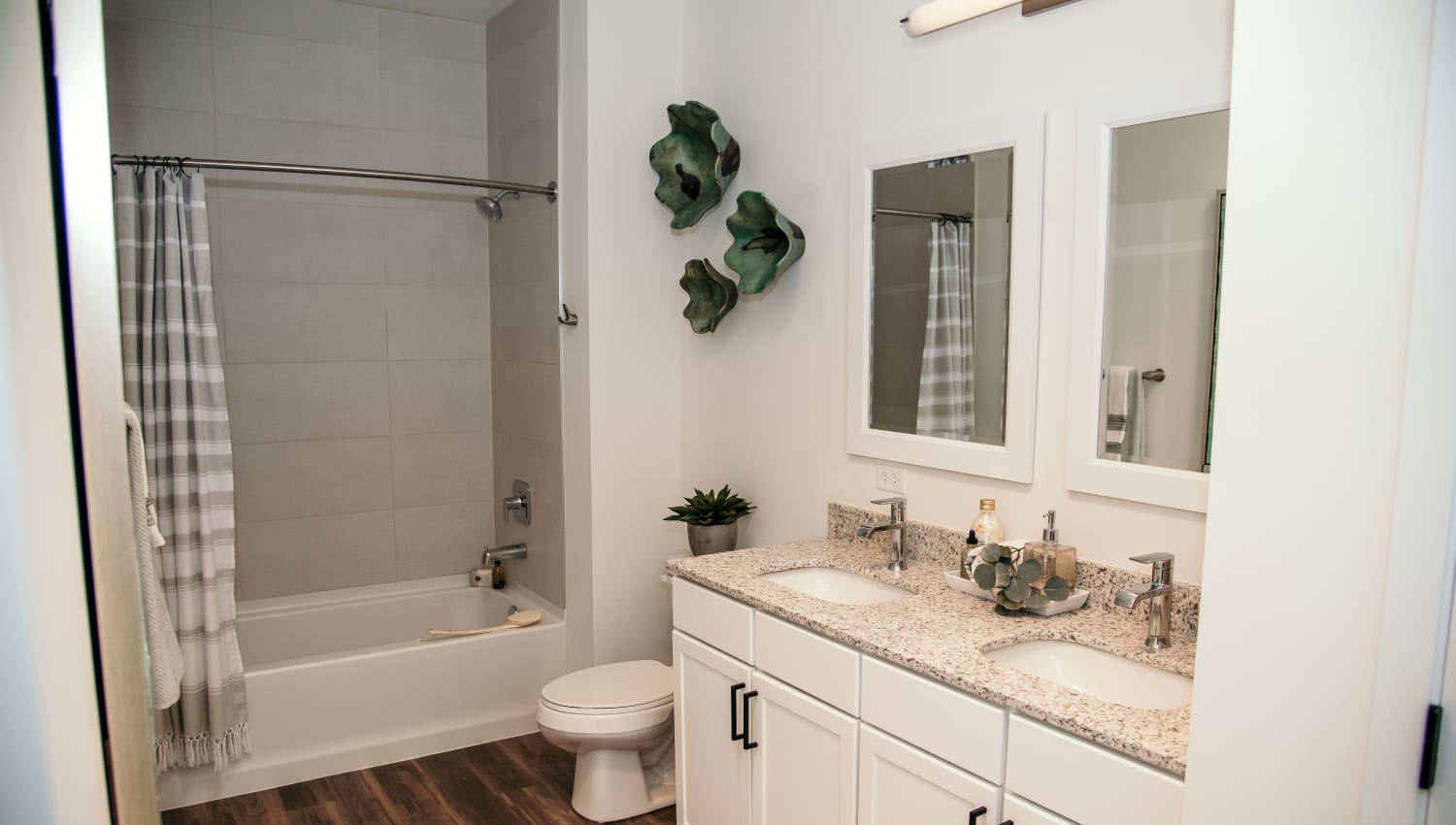 Bright bathroom with double sink and full size bathtub at The 450 in Lombard, Illinois