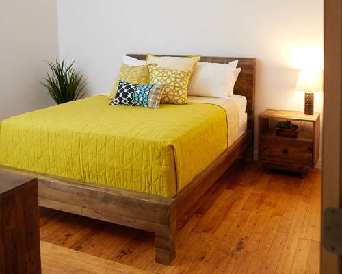 Bright bedroom with wood flooring at Revolution Mill in Greensboro, North Carolina