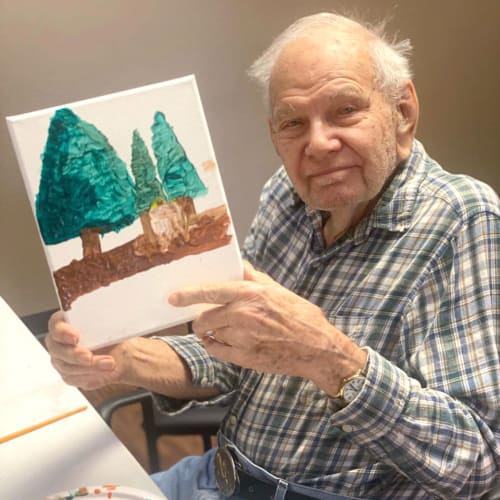 Gentleman showing off a painting at FountainBrook in Midwest City, Oklahoma