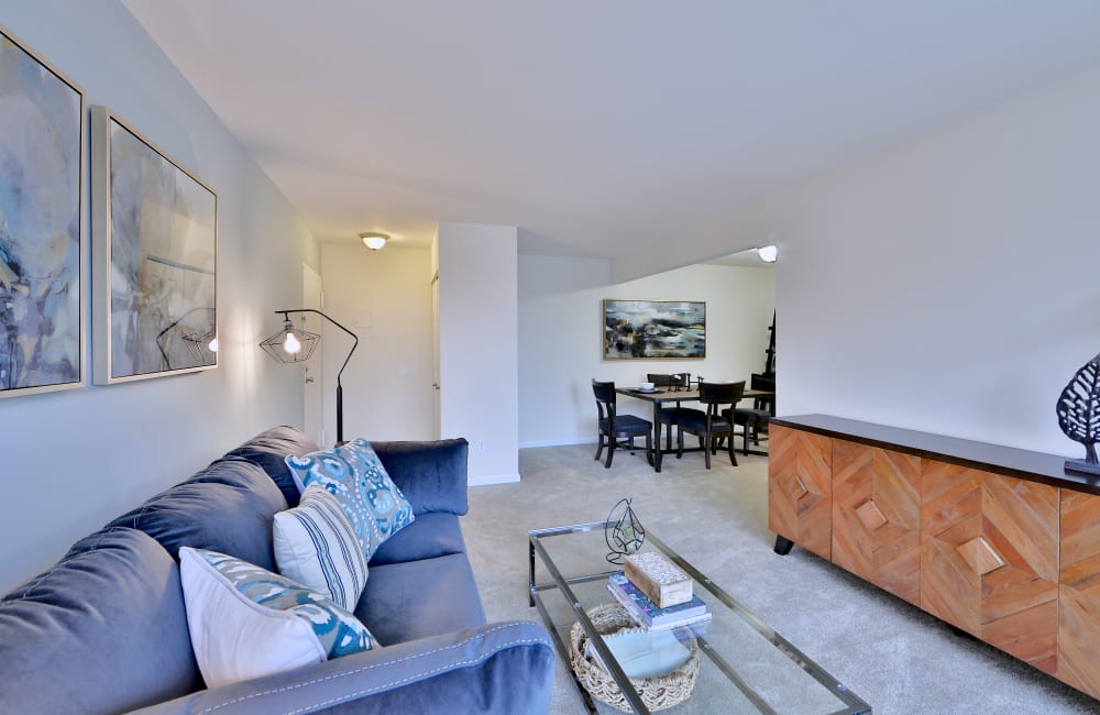 Living room with plank flooring in a model home at Chesapeake Glen Apartment Homes in Glen Burnie, Maryland