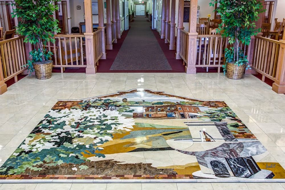 Main lobby with tile mosaic at Addington Place of Des Moines in Des Moines, Iowa.