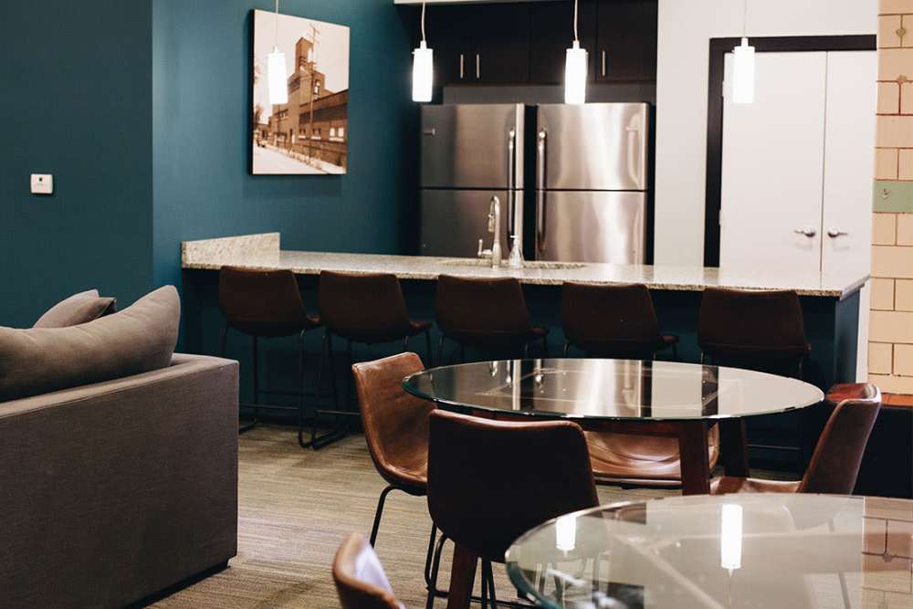 Modern kitchen with granite countertops and bar seating at Courtyard Lofts at Scott’s Addition in Richmond, Virginia