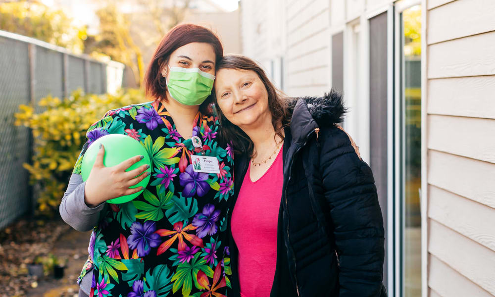 Happy resident and caregiver at Cascade Park Gardens Memory Care in Tacoma, Washington