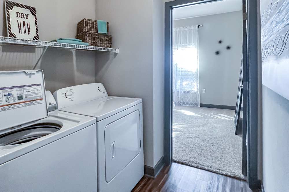 Modern laundry area featuring efficient appliances and stylish décor at District 119 in Oklahoma City, Oklahoma.