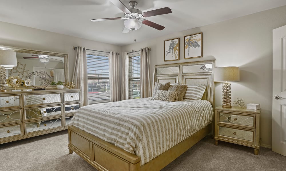 Cozy master bedroom with ceiling fan at Cottages at Abbey Glen Apartments in Lubbock, Texas