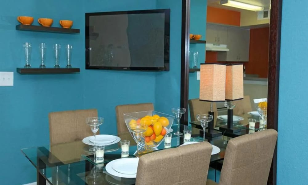 A glass dining table and chairs in a model apartment at Vero Green in Vero Beach, Florida