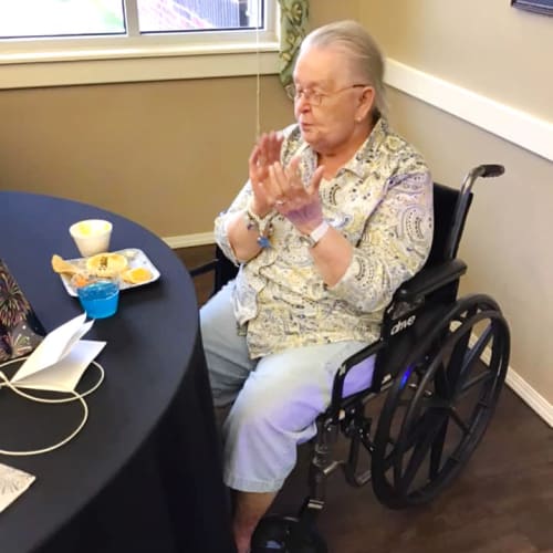 Seated team member eating breakfast at Canoe Brook Assisted Living & Memory Care in Catoosa, Oklahoma