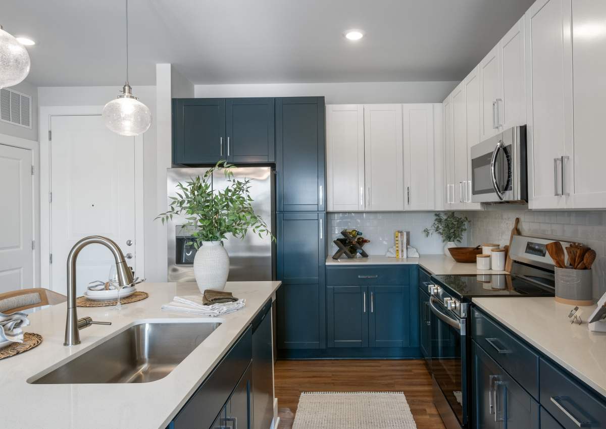 Blue cupboards in a home's kitchen at Proximity Carolina Beach in Carolina Beach, North Carolina