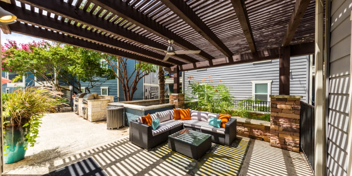 BBQ and gazebo area with cushioned couches at Austin Midtown in Austin, Texas