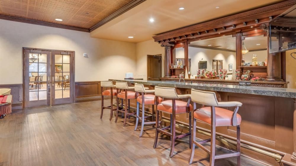 Dining area with bar at Oxford Vista Wichita in Wichita, Kansas