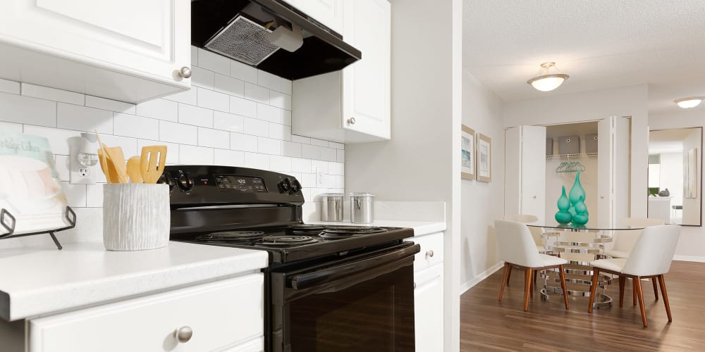 Beautiful white cabinets and wood style flooring at The Avenue in Ocoee, Florida