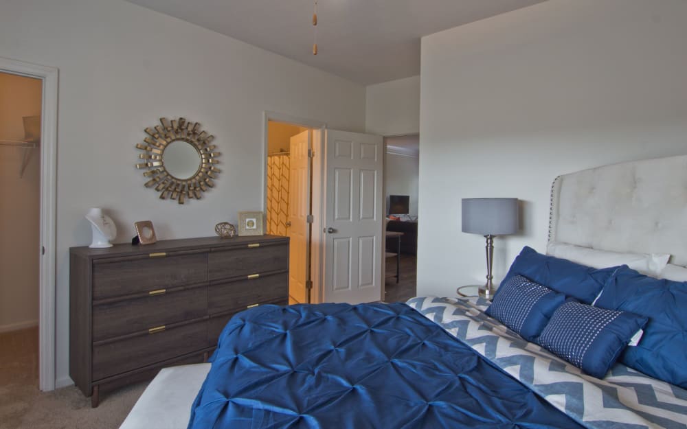 Model bedroom with ensuite bathroom and walk-in closet at Easton Commons Apartments & Townhomes in Columbus, Ohio