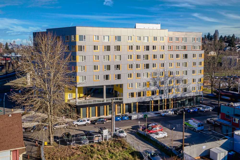 Front exterior view of apartments with parking area at Gardner House in Seattle, Washington
