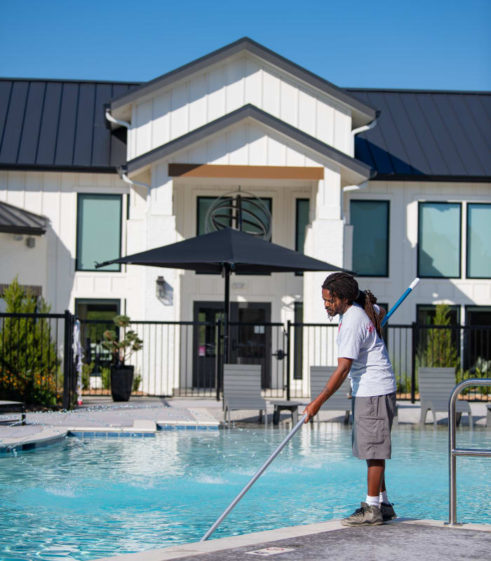 Employee cleaning the pool at Case & Associates