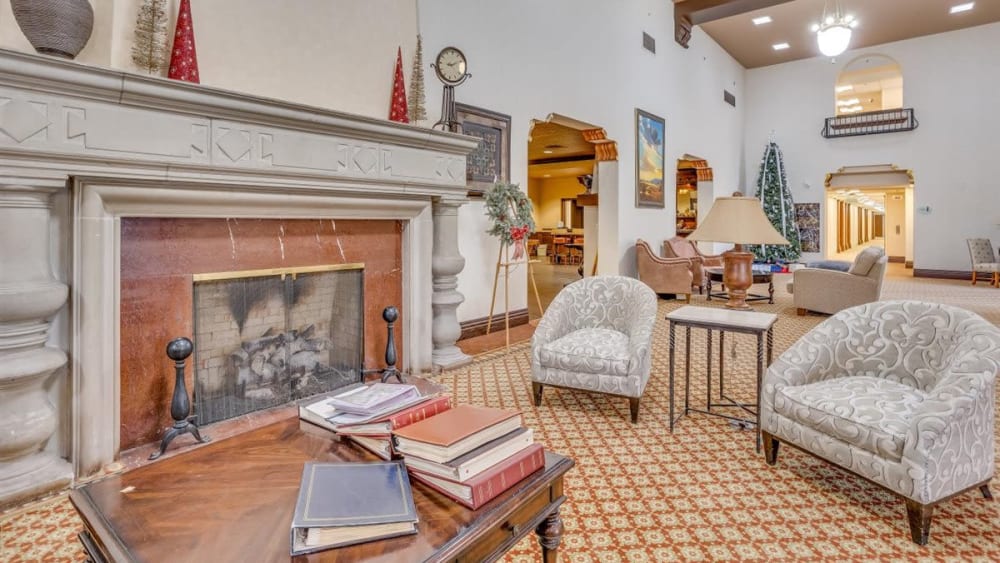 Cozy fireplace and seating area in the lounge at Oxford Vista Wichita in Wichita, Kansas