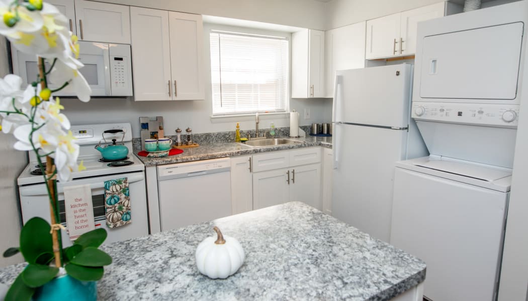 Kitchen with dining area in background in model home at The Residences at Forest Grove in Newport News, Virginia