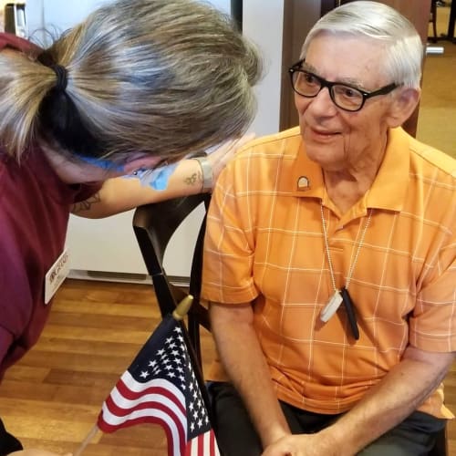 Resident talking to a masked caretaker at The Oxford Grand Assisted Living & Memory Care in Wichita, Kansas