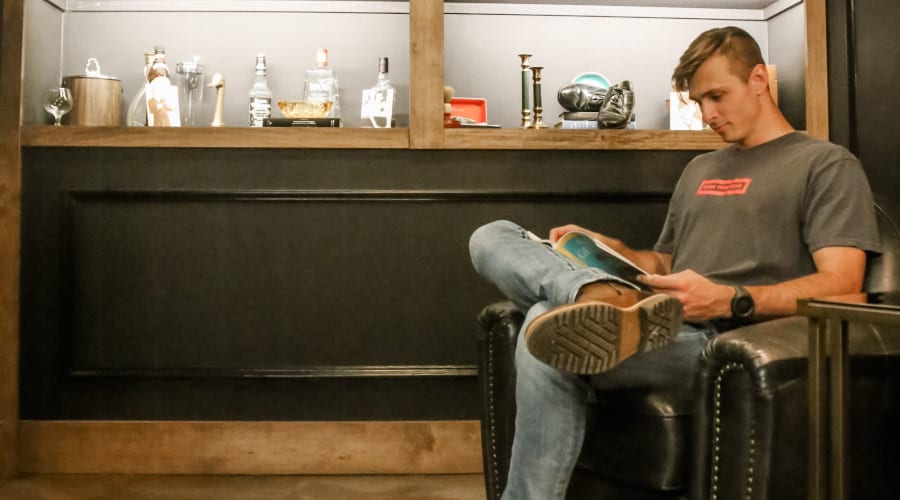A student reading a book at University Lofts Downtown, Jonesboro, Arkansas