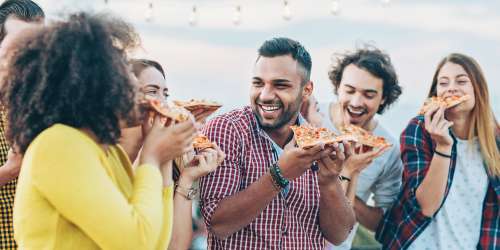 Residents having pizza near North Bend Living in Houston, Texas