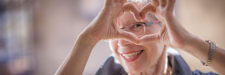 Resident making a heart with her hands at Ingleside Communities in Mount Horeb, Wisconsin