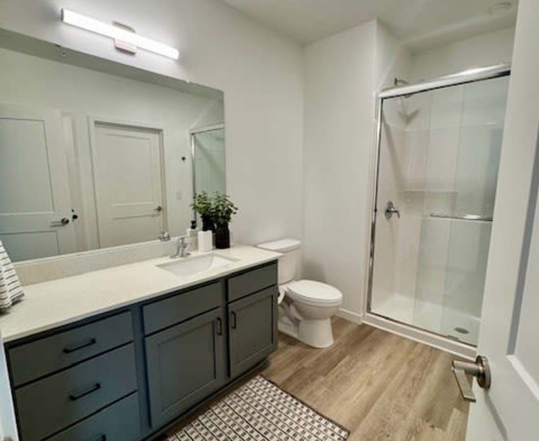 Vanity with sink and mirror in bathroom at Pritchard Park Place in Racine, Wisconsin