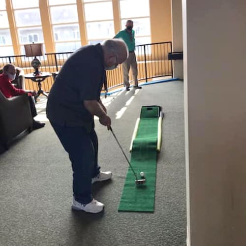 Resident playing minigolf at The Oxford Grand Assisted Living & Memory Care in McKinney, Texas