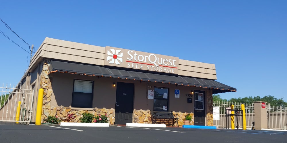 Exterior of the main entrance to StorQuest Self Storage with electronic gate access in Sarasota, Florida