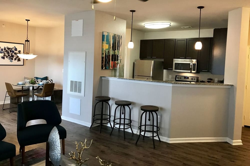 Model kitchen with barstool seating at Creekside at Kenney's Fort in Round Rock, Texas