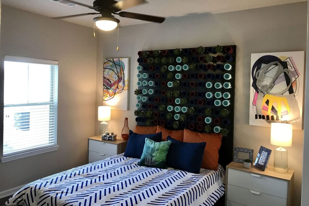 Model bedroom with ceiling fan at Creekside at Kenney's Fort in Round Rock, Texas