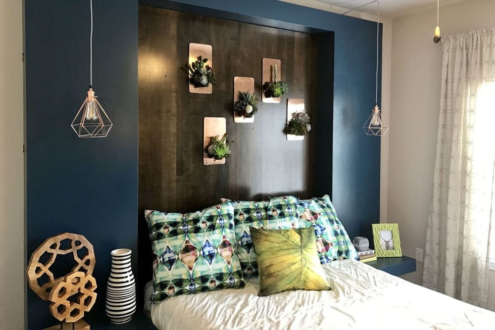 Beautiful model bedroom with pendant lighting at Creekside at Kenney's Fort in Round Rock, Texas