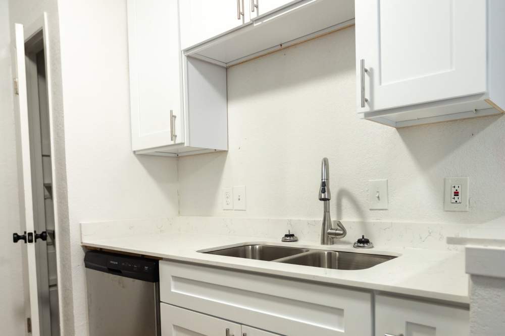 Kitchen with wooden cabinets at Lakeshore Villa Apartments in Rowlett,Texas