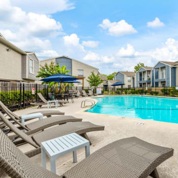 Lounge chairs by the pool at Westbury Crossing in Houston, Texas