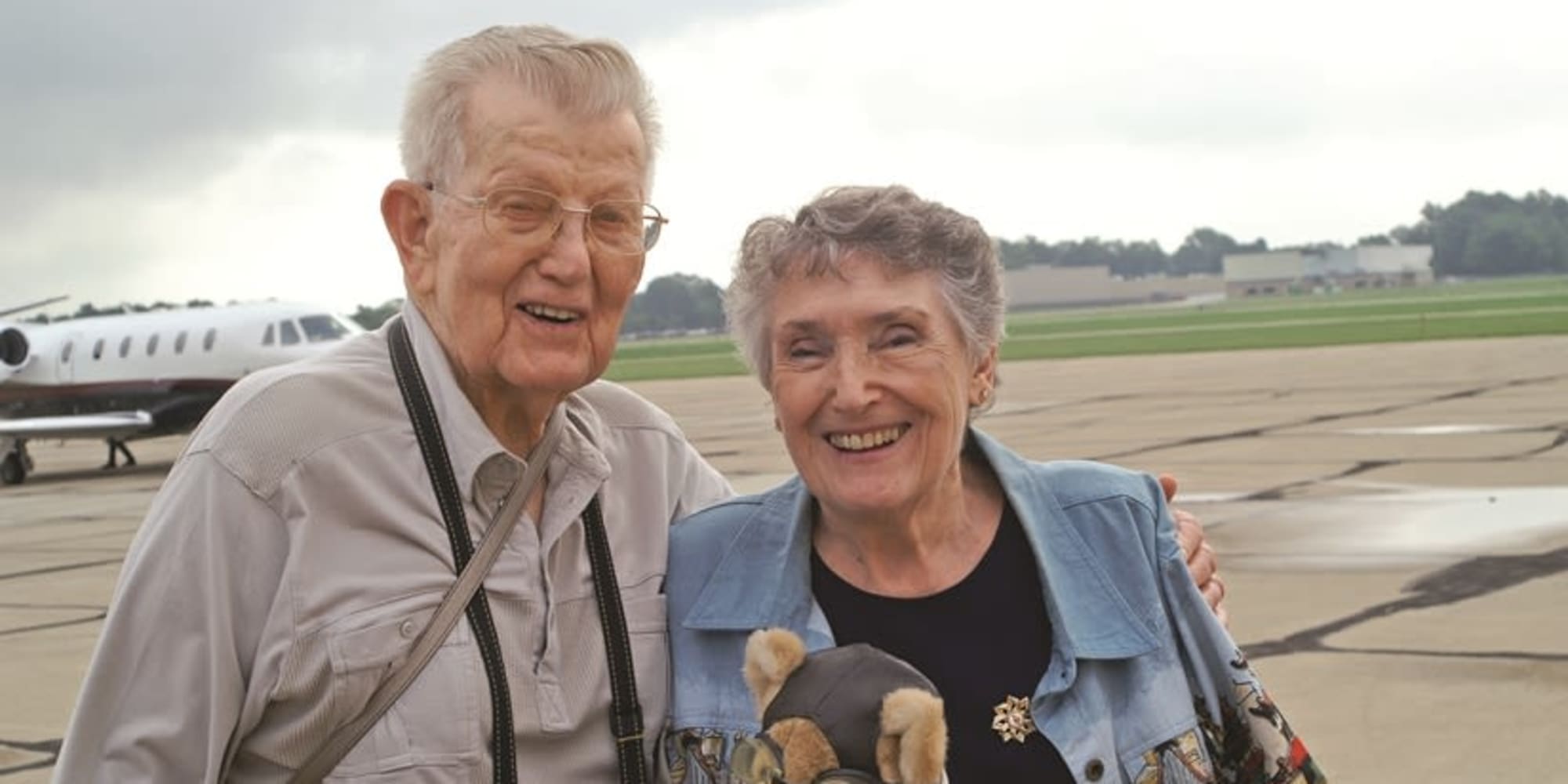 Two residents from Birchwoods at Canco Assisted Living in Portland, Maine in front of a plane