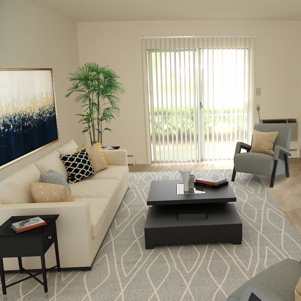Model living room with sliding door access to a private patio at Edgewater Gardens Apartment Homes in Long Branch, New Jersey