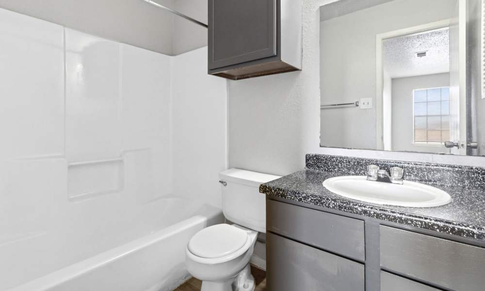 Bathroom with vanity storage and bathtub at Arbors of Taylor in Taylor. TX