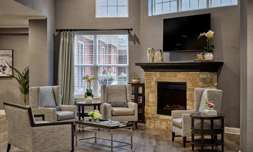 Cozy fireplace sitting area at Waltonwood Cotswold in Charlotte, North Carolina  