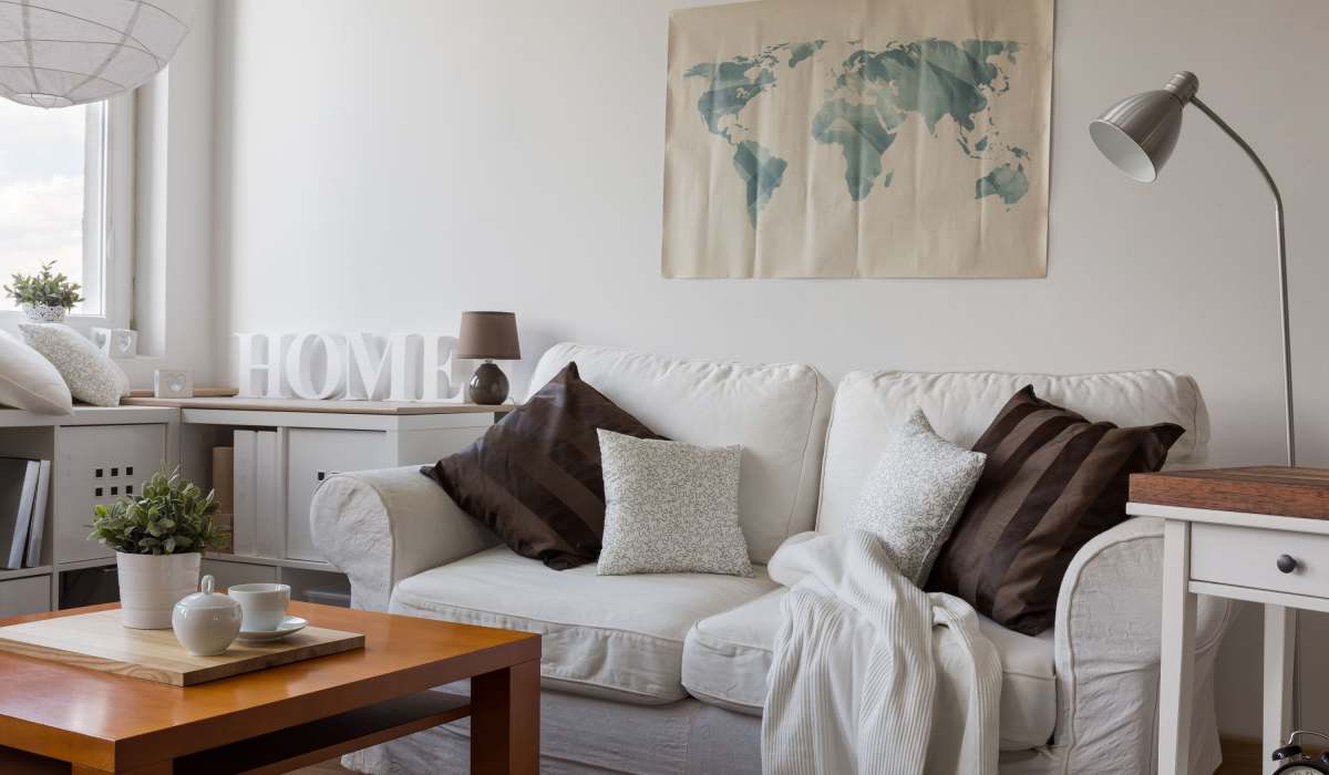 model furnished living room with a world map on the wall at Crabapple Chase in Anderson, South Carolina