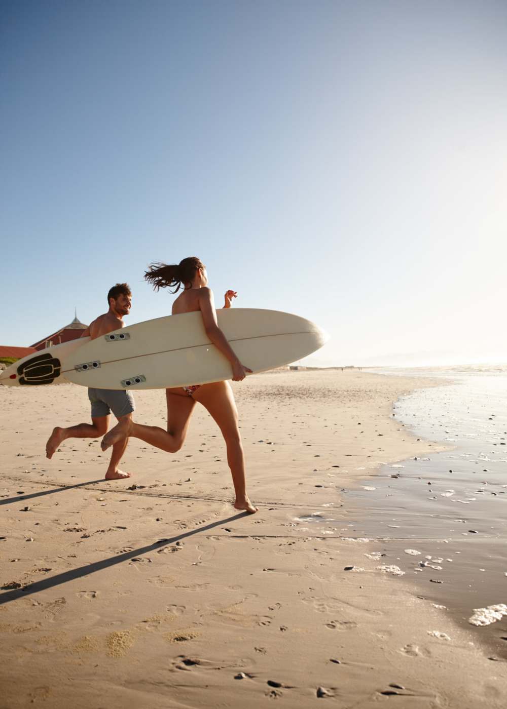 Happy residents running towards the beach at Alamar at Fernwood Forest in Indiantown,Florida